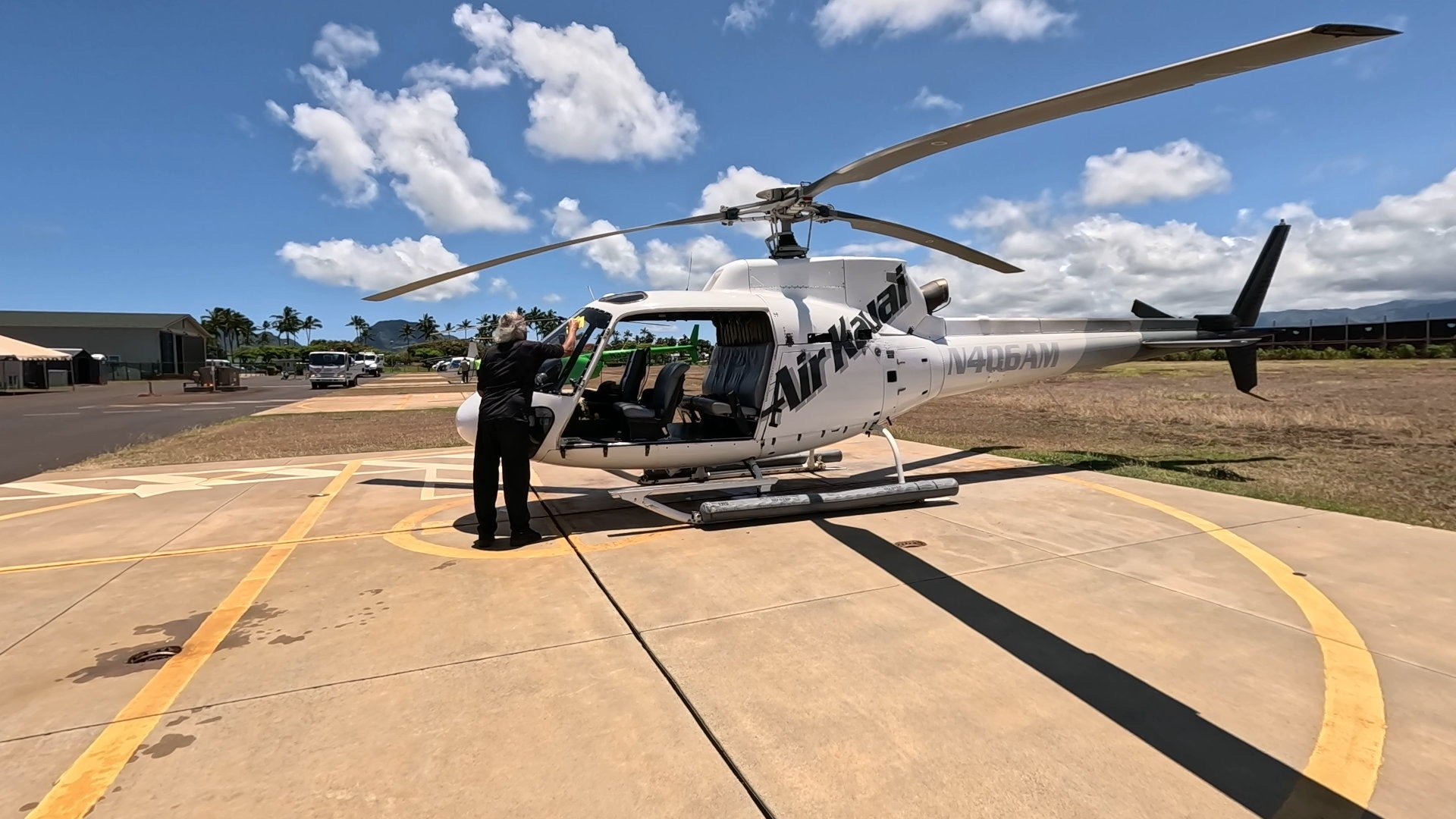 ASTAR helicopter on the tarmac with doors removed and its passenger seats visible